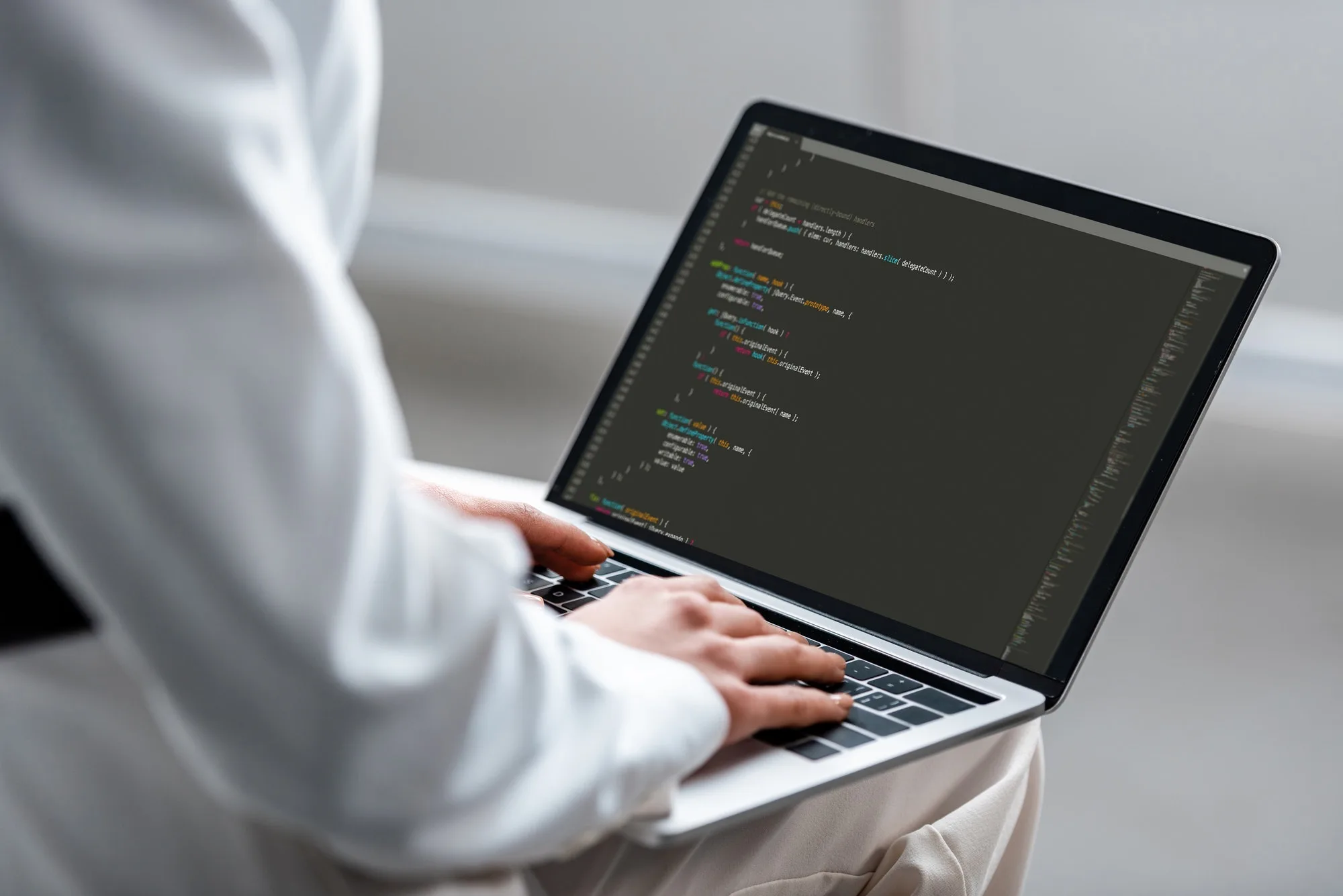 cropped view of woman using laptop with microsoft windows on screen at office desk