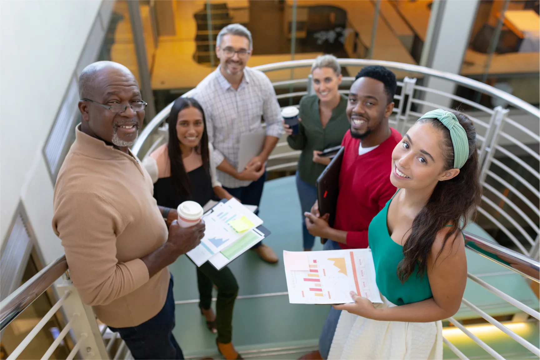 high angle portrait of smiling multiracial male teaching students