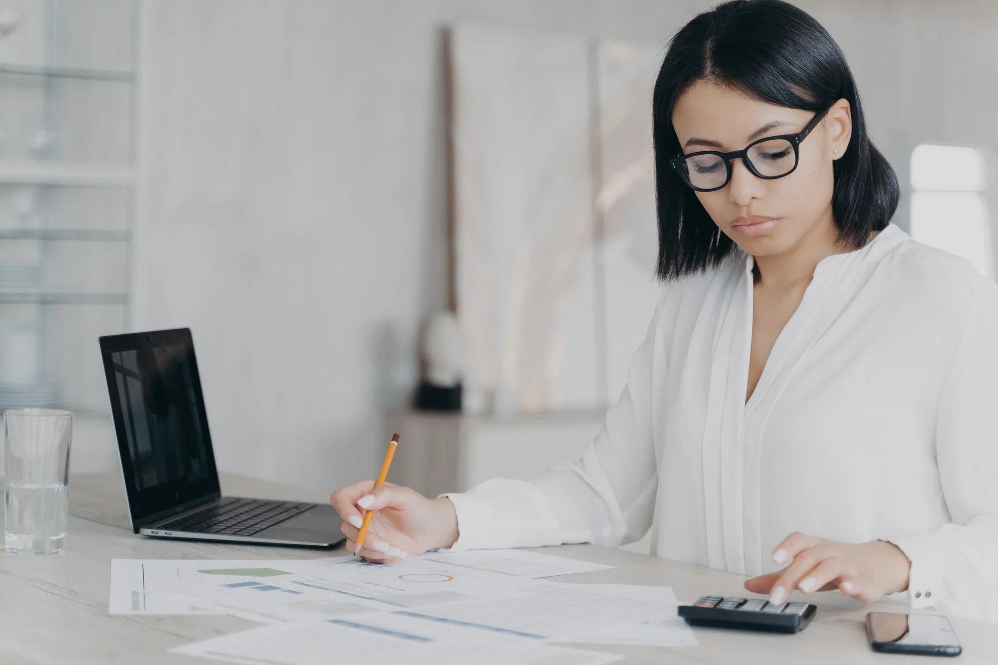 remote accountant is calculating profit young hispanic bookkeeper is working distantly from home 