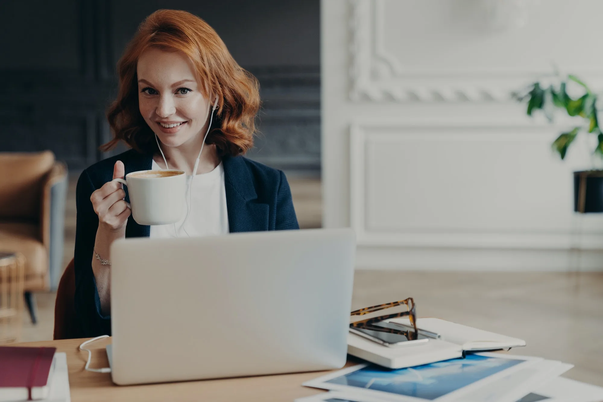 woman watches training webinar on laptop computer browses information for project