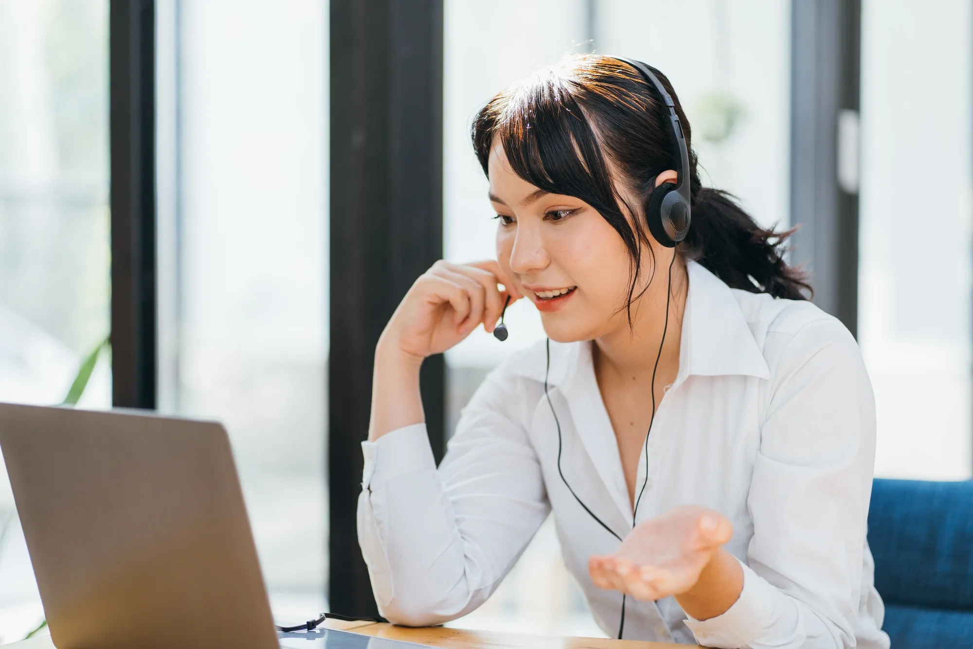 young friendly operator woman agent with headsets working in a call centre 