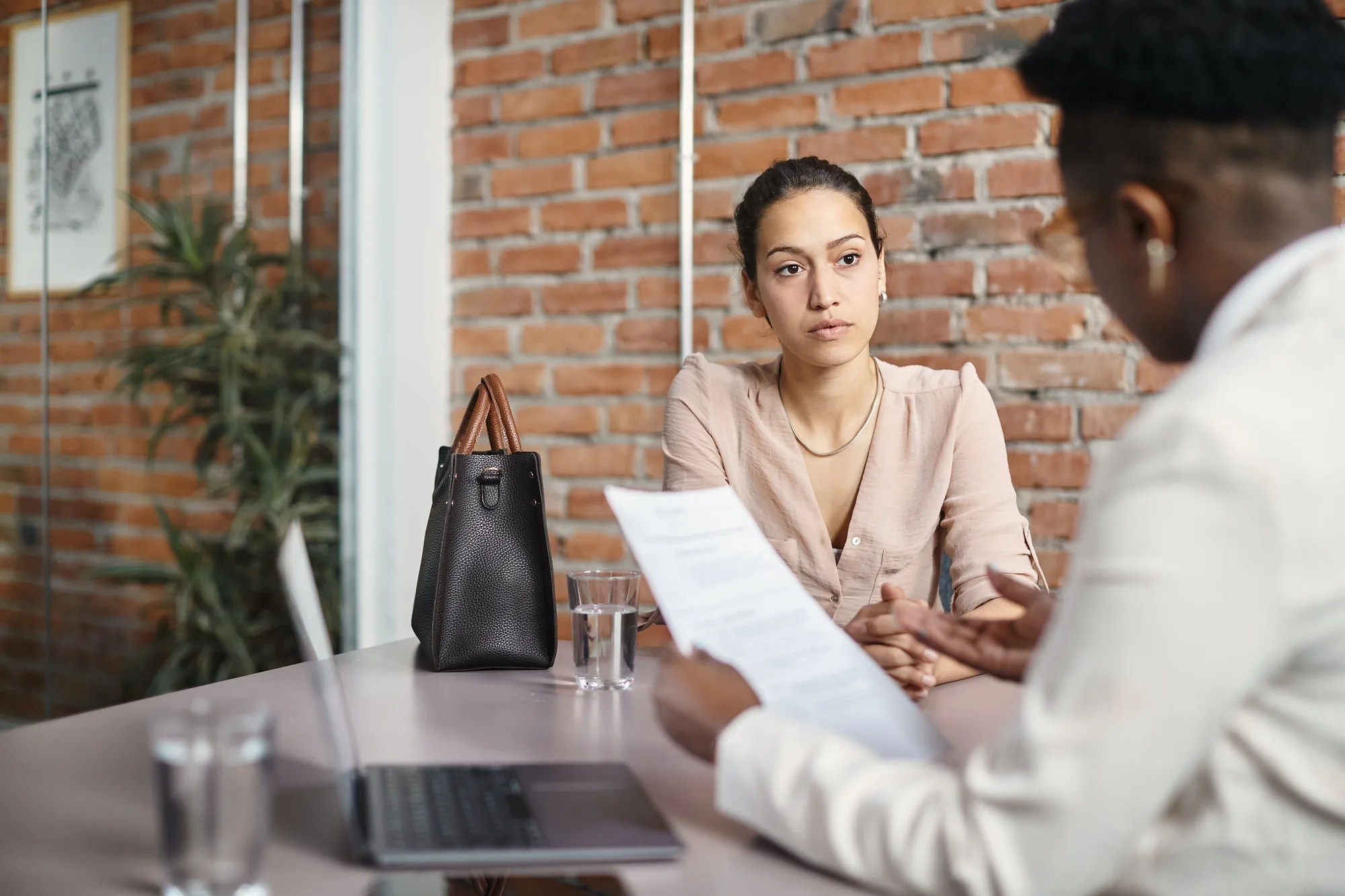 young woman having job interview at corporate office 